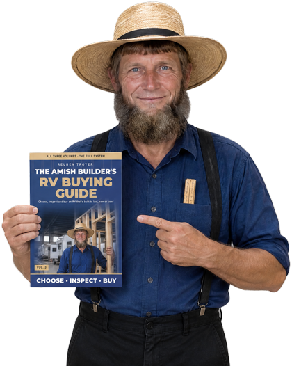 Reuben Troyer holding The Amish Builder's RV Buying Guide